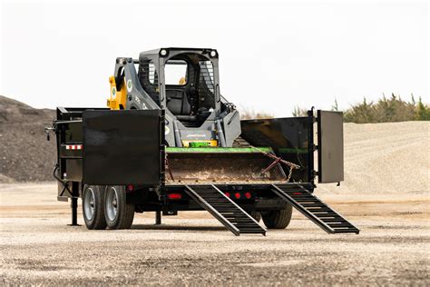 skid steer in dump trailer